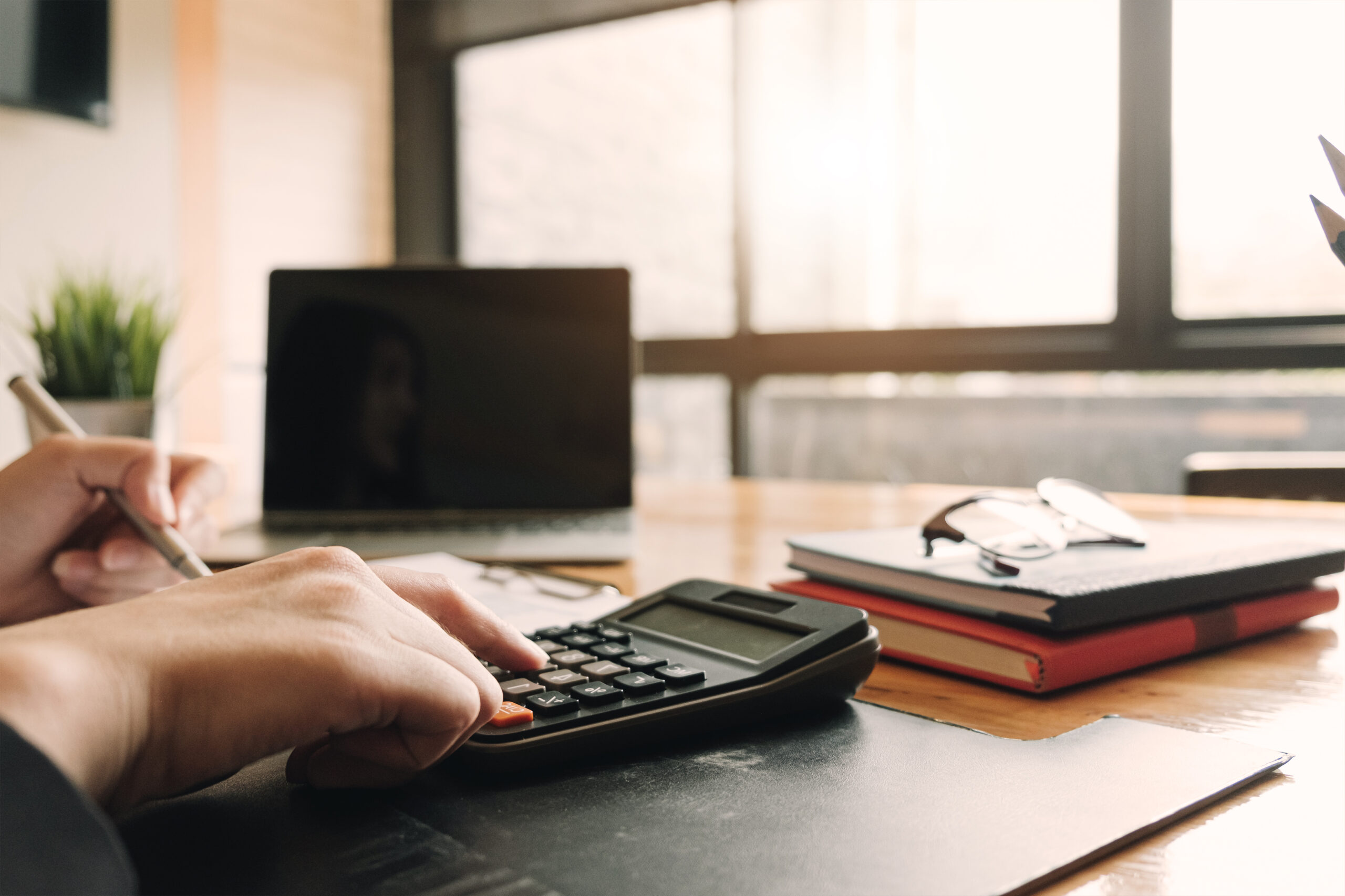 Accountant using a calculator to calculate the numbers. Accounting , Accountancy from financial report and calling to consultant, Calculation Concept.